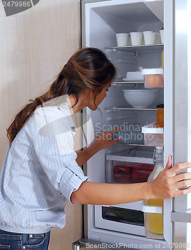 Image of woman looking in the fridge