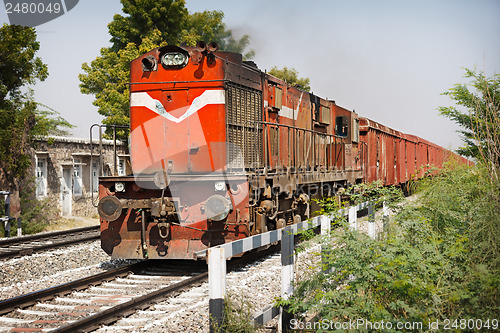Image of Old locomotive pulling freight train