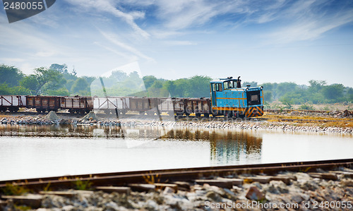 Image of Old small locomotive and freight train