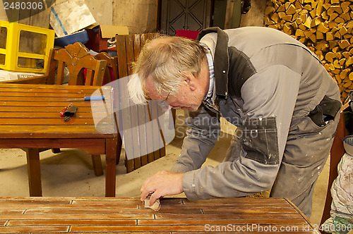 Image of Man using sandpaper