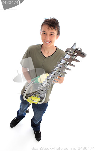 Image of Smiling young male with garden tool