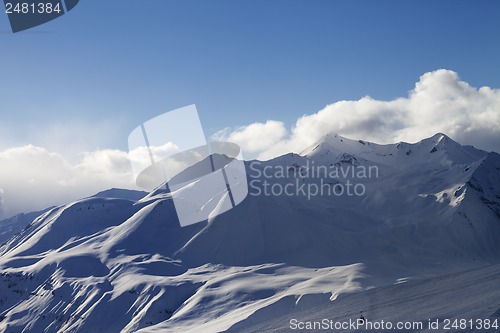 Image of View on ski slope and sunlight mountains in evening