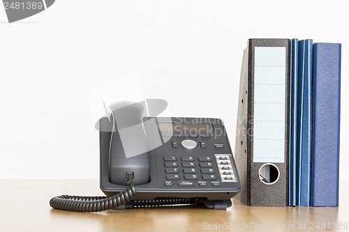 Image of modern business phone with ring binder