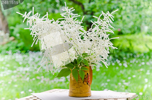 Image of Bouquet of wild flowers in a pot at the table  
