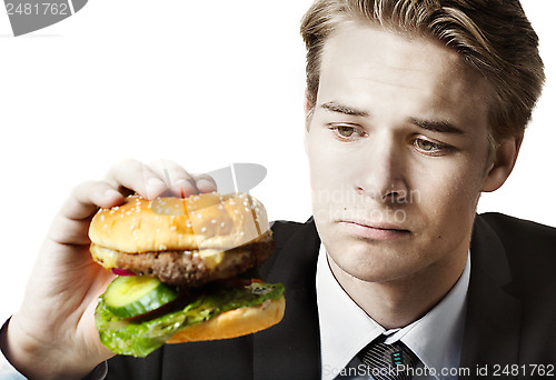 Image of Businessman eating at work