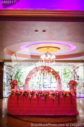 Image of Floral arch and a table