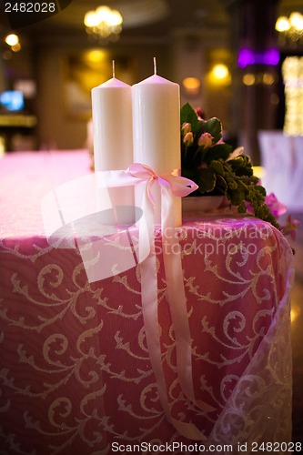 Image of candles tied with a pink ribbon