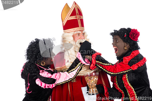 Image of Zwarte Piet giving pepernoten (cookies) to Sinterklaas