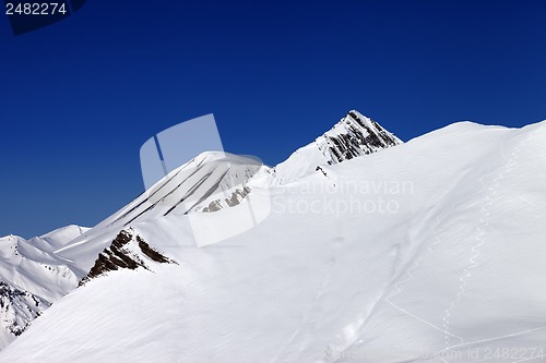 Image of Off-piste slope with traces of skis in nice day