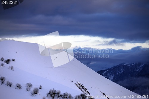 Image of Off-piste slope and cloudy sky at sunset