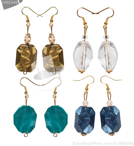 Image of Earrings made of plastic and glass on a white background. Four p