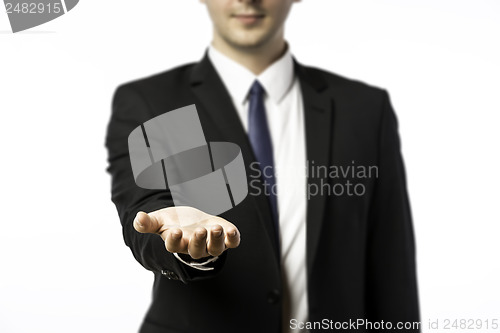 Image of Businessman holds out his hand