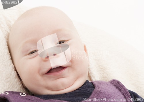 Image of newborn child laughing to camera