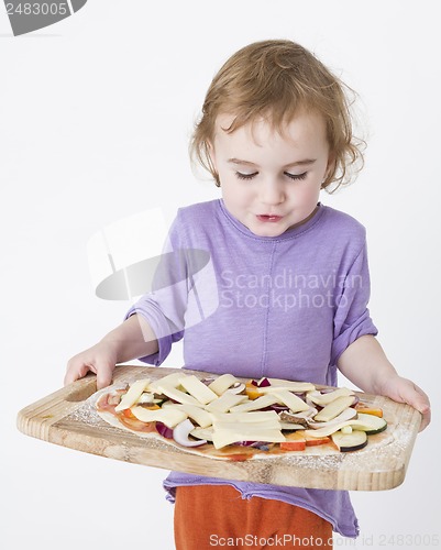 Image of bringing pizza to the oven