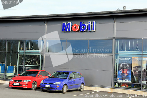 Image of Sign Mobil on a Shop Wall with Red and Blue Cars