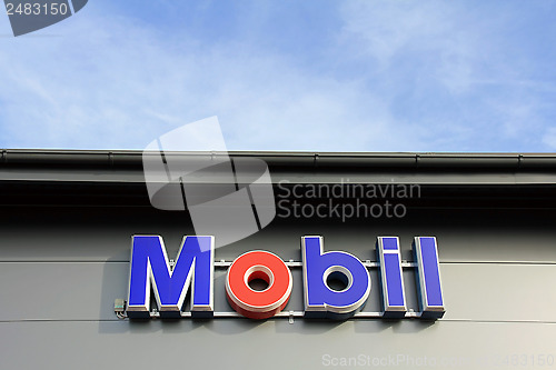 Image of Sign Mobil on a Shop Wall with Blue Sky