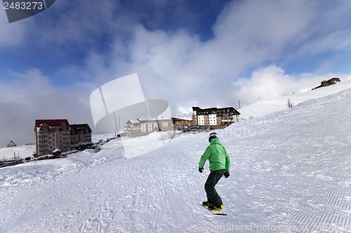 Image of Hotels on ski resort and snowboarder on slope