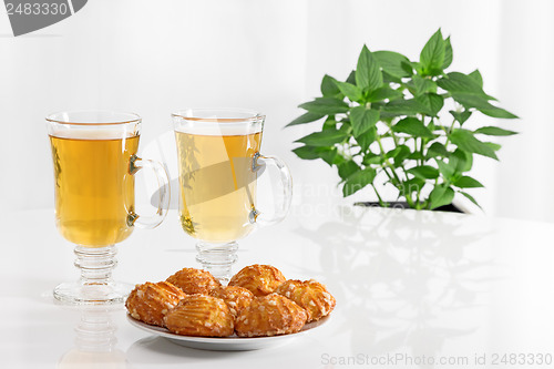Image of Tea in glass cups and tasty cookies