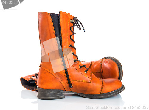 Image of Orange leather boots on white background