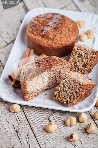 Image of sliced fresh buns, hazelnuts and cinnamon 