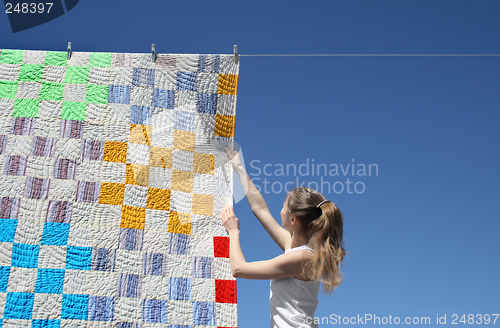 Image of Girl and bright laundry