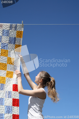 Image of Young woman and bright laundry