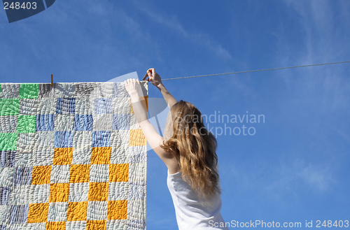 Image of Longhaired girl and bright laundry