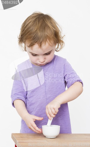 Image of child working with mortar