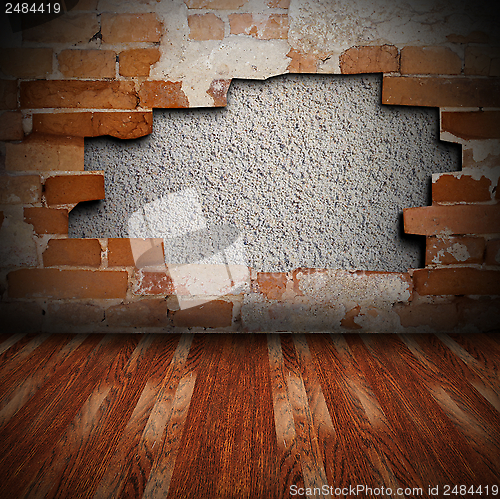 Image of cracked wall and wooden floor