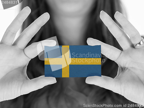 Image of Woman showing a business card