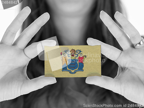 Image of Woman showing a business card