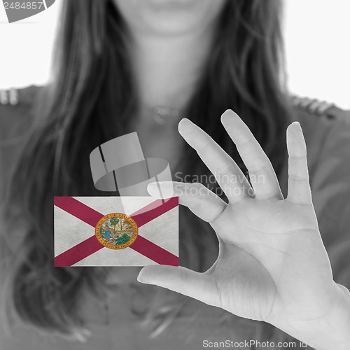 Image of Woman showing a business card