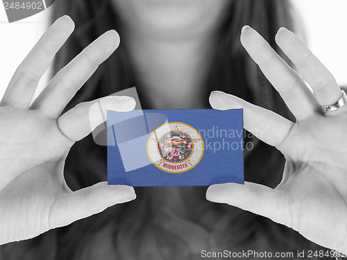 Image of Woman showing a business card