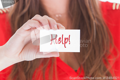 Image of Woman in red showing a business card