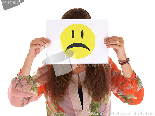Image of Young woman holding paper with unhappy smiley