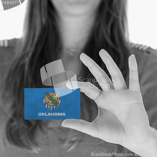 Image of Woman showing a business card