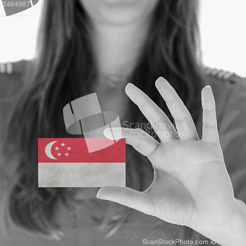Image of Woman showing a business card