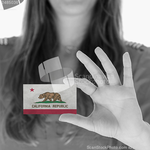Image of Woman showing a business card