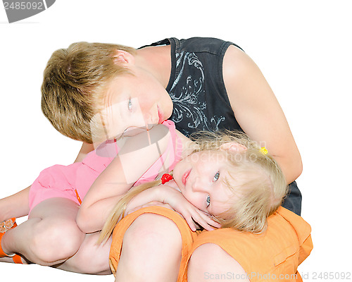Image of Two kids brother and sister curled up together