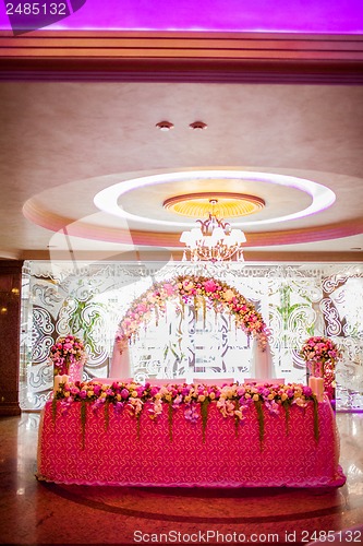 Image of Floral arch and a table