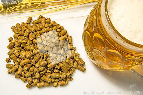 Image of Hops pellets with beer glass
