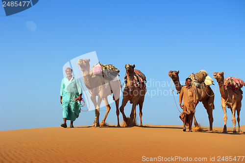 Image of cameleers in desert