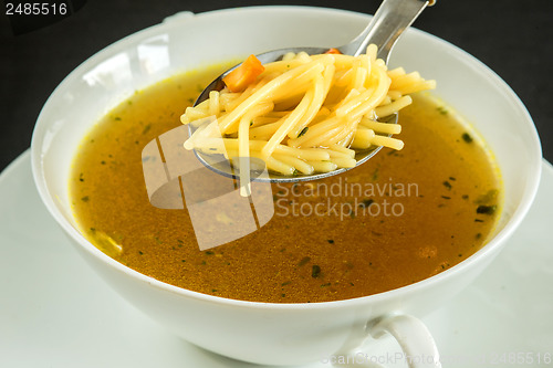 Image of beef broth with noodles