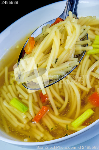 Image of beef broth with noodles