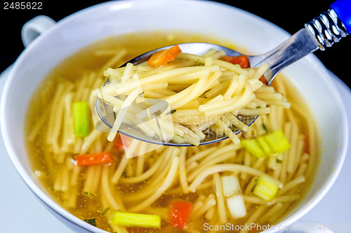 Image of beef broth with noodles