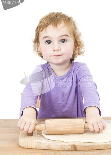 Image of young child rolling out dough