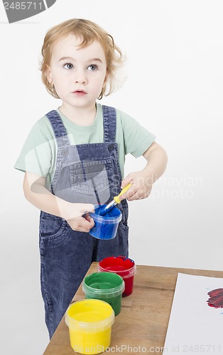 Image of little girl with brush in paint tub