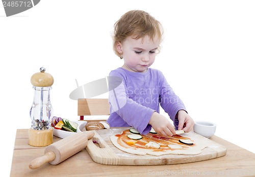 Image of child making fresh pizza