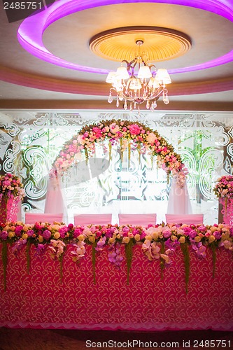 Image of Floral arch and a table