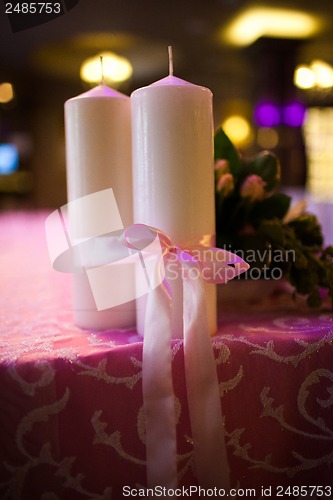 Image of candles tied with a pink ribbon